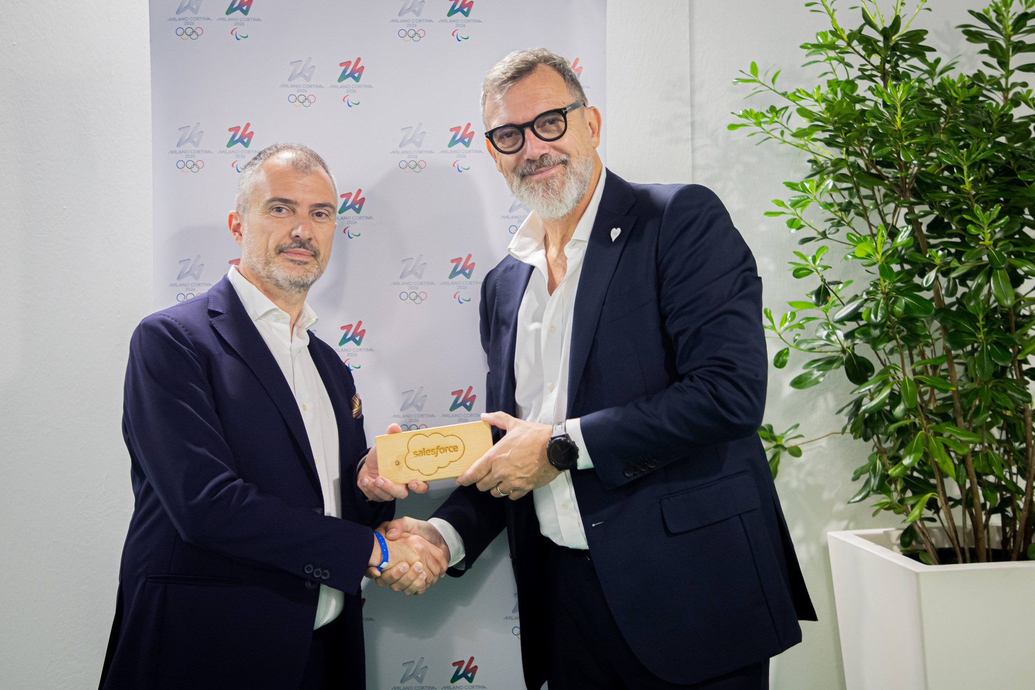 Michele Bensi, Head of Marketing Italy | Salesforce and Nevio Devidè, Marketing, Licensing & Events Director of Milano Cortina 2026 mark their organisations' partnership for the Games ©Milan Cortina 2026