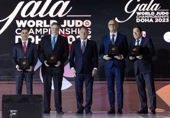 IJF President Marius Vizer, centre, handed out a series of gold plaque at a gala dinner staged during the World Judo Championships in Doha ©IJF