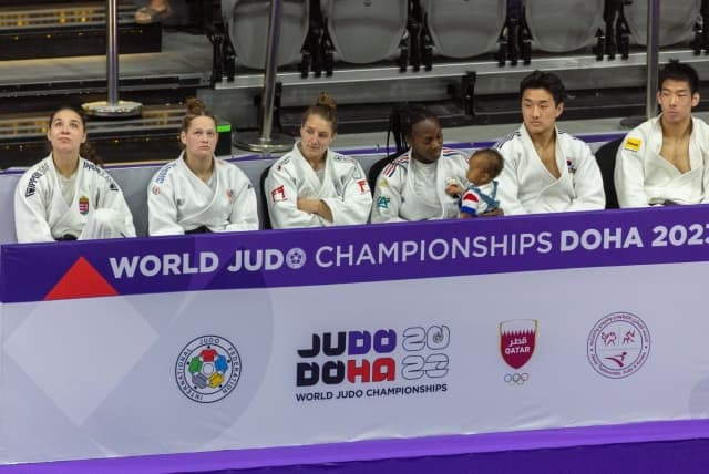 France's Clarisse Agbégnénou, third from right, holds her daughter, Athena, after securing women's under-63kg gold in Doha ©IJF