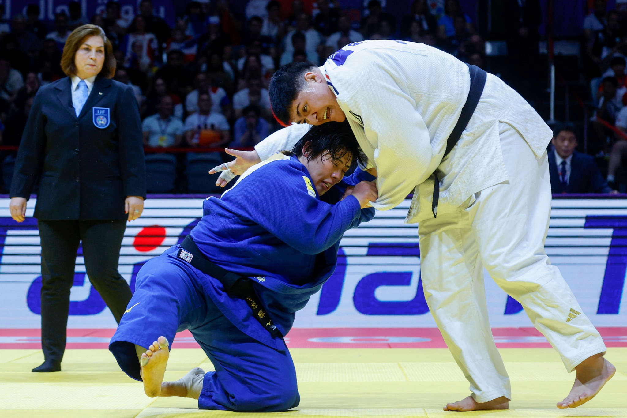 Japan’s Akira Sone, left, drags down the towering French judoka Julia Tolofua in the women's over-78kg final ©Getty Images
