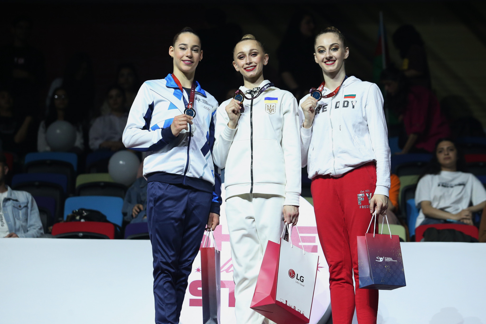 
Ukrainian Viktoriia Onopriienko, centre, mastered the hoop event, bagging a total score of 33.250 for the gold medal ©AGF