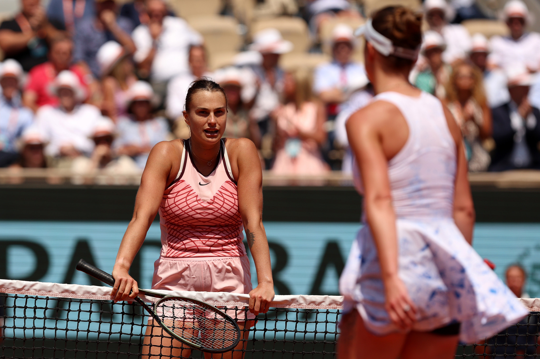 Elina Svitolina, refused to shake hands with Aryna Sabalenka, pictured standing at the net, following their French Open quarter-final in Paris ©Getty Images