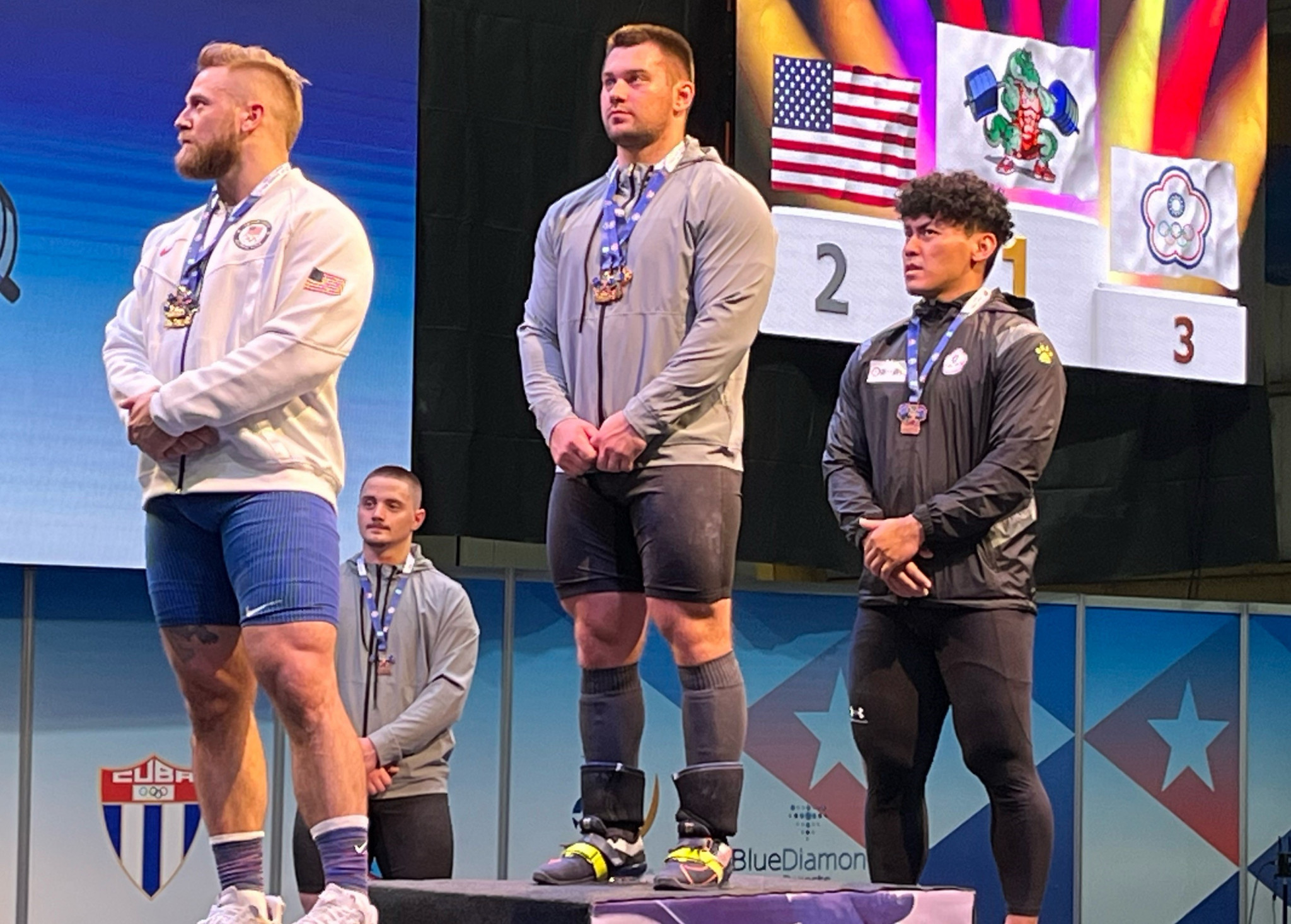 Yauheni Tsikhantsou, centre, made a winning return as an Individual Neutral Athlete in the men's 102kg ©Brian Oliver