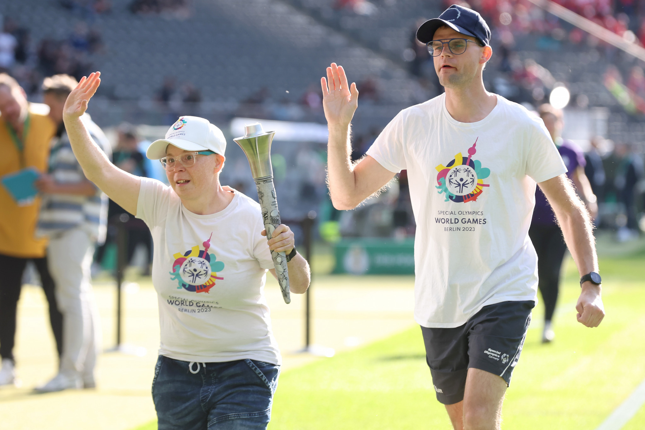 Daniela Huhn, left, and Jann Rathenow, right, with the Berlin 2023 Special Olympics World Games Torch at the DFB Cup final match between RB Leipzig and Eintracht Frankfurt on June 03 ©Getty Images 