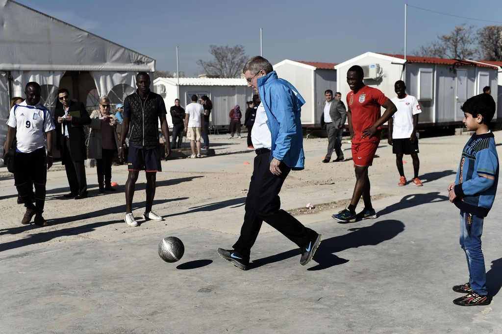 IOC President Thomas Bach plays football at the Elaionas camp for migrants and refugees in Athens