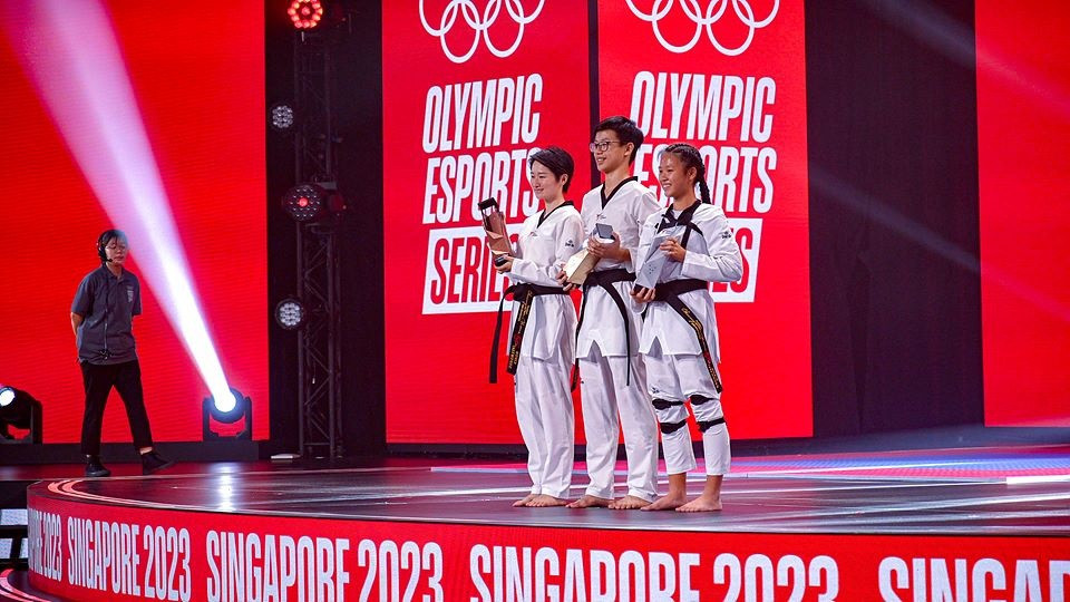 Two-time Olympic champion Wu Jingyu of China, left, takes to the podium ©World Taekwondo
