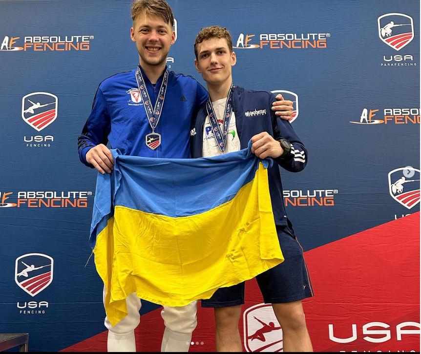 Konstantin Lokhanov, left, poses with the Ukraine flag on the podium at the USA Fencing Summer Nationals, alongside Darii Lukashenko ©Instagram