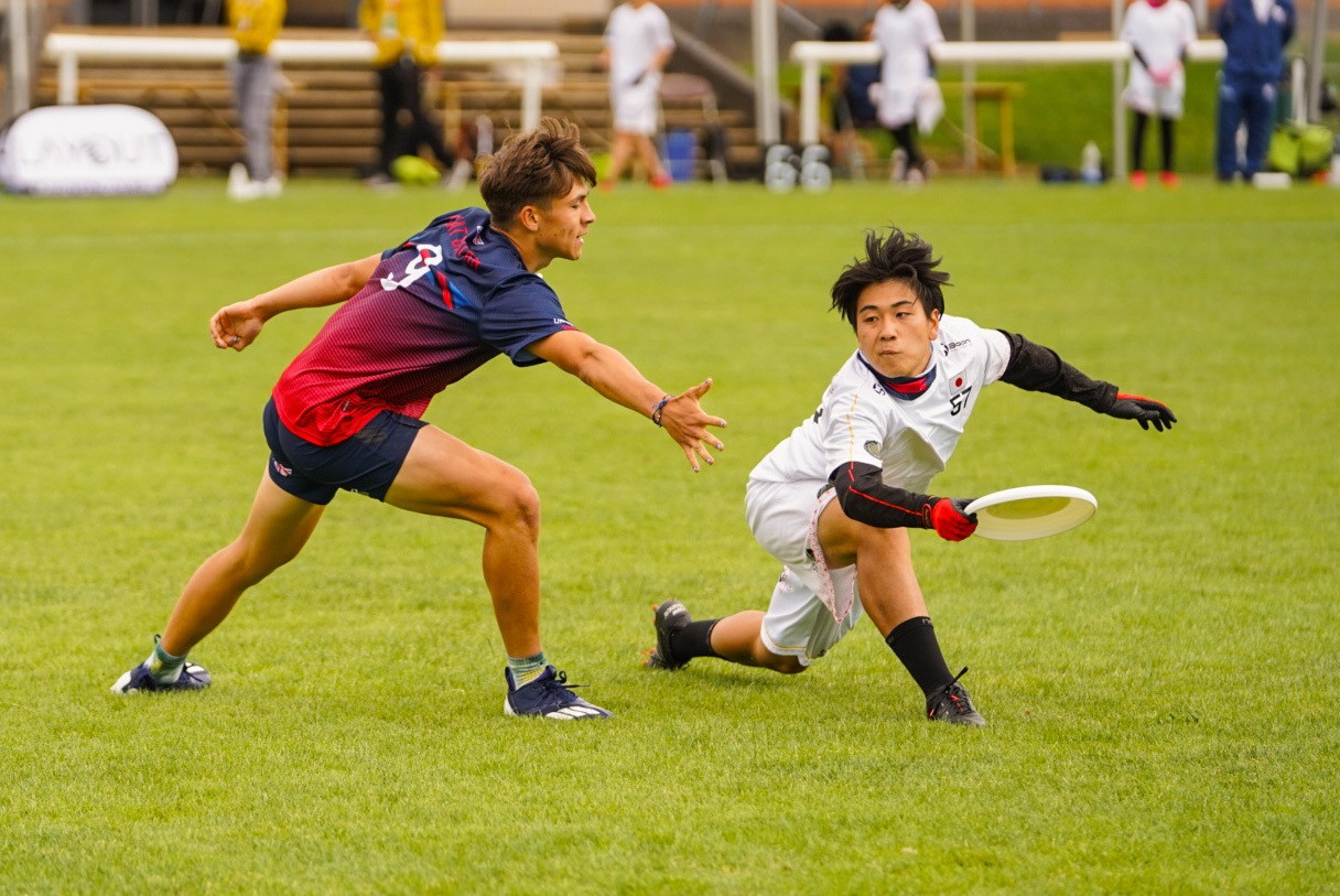A Japanese player tries to find room to send the disc away against Britain ©WFDF