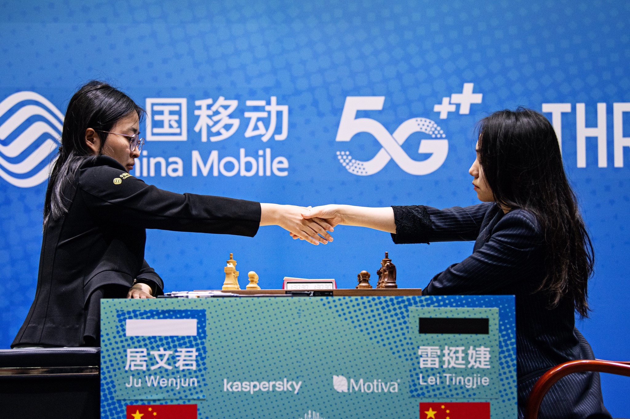 Ju Wenjun, left, and Lei Tingjie shake hands after game two of the FIDE Women's World Championship Match ended in a draw ©FIDE/Stev Bonhage