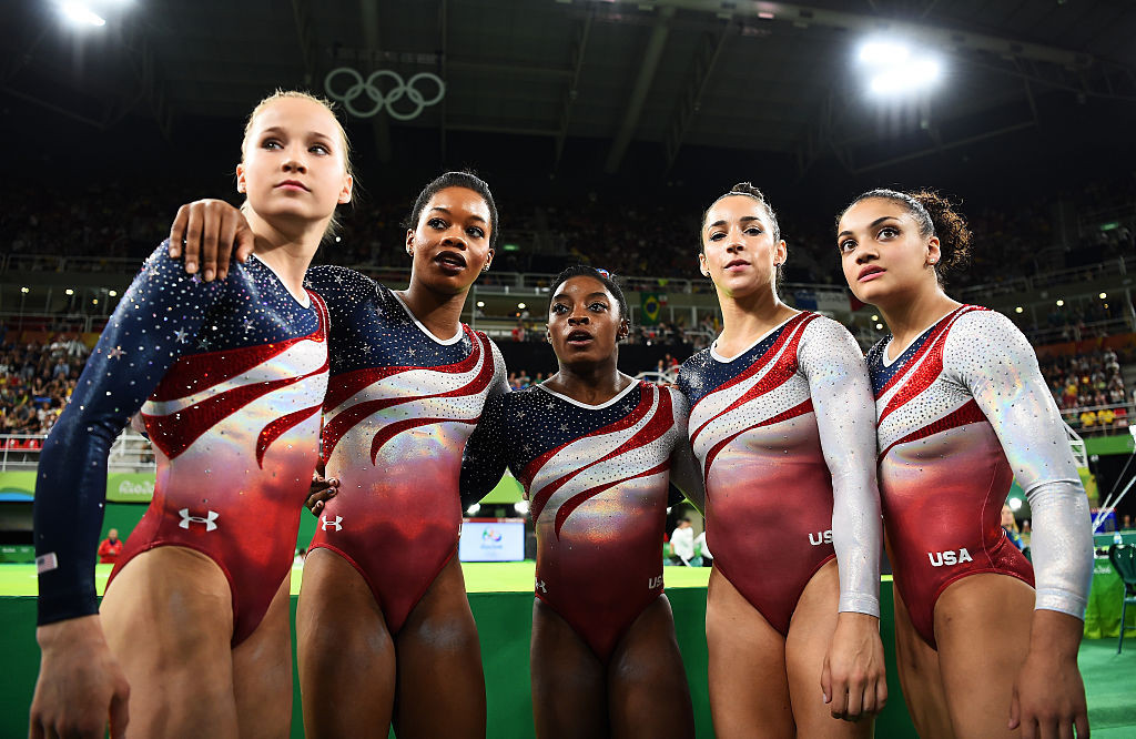 Gabby Douglas, second left, and Simone Biles, centre, await confirmation of their artistic gymnastics team victory at the Rio 2016 Games - both may yet appear in the Paris 2024 Games ©Getty Images