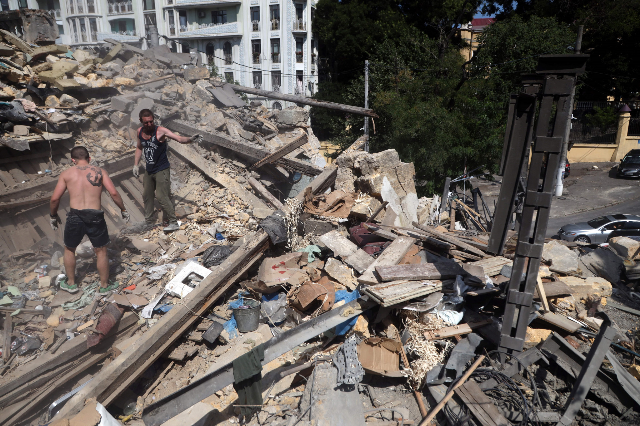 Workers clear the rubble in the centre of Ukrainian city of Odesa following a missile attack ©Getty Images