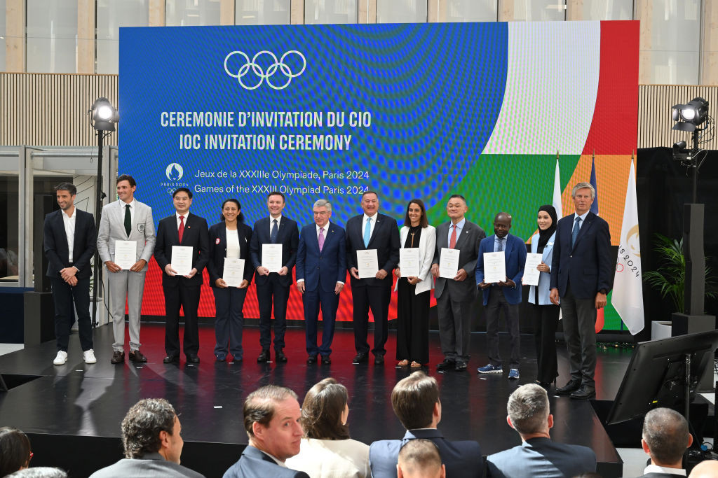 Recipients of the first direct IOC invitations to the Paris 2024 Games line up at the ceremony in the Organising Committee headquarters today ©Getty Images