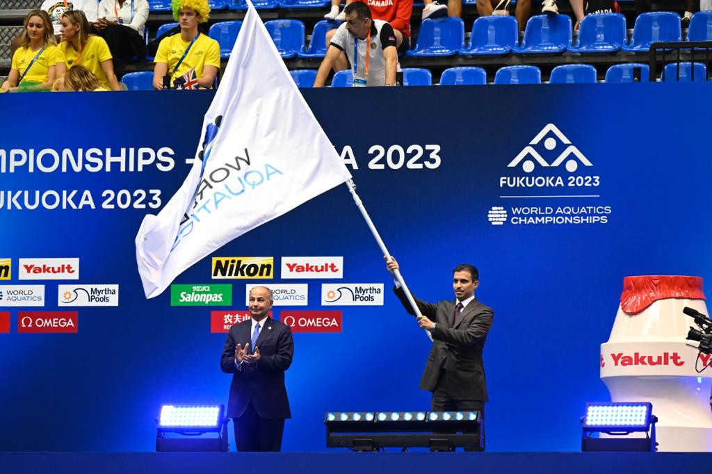 The emblem was unveiled during the flag handover ceremony at the Fukuoka 2023 World Aquatics Championships ©QOC