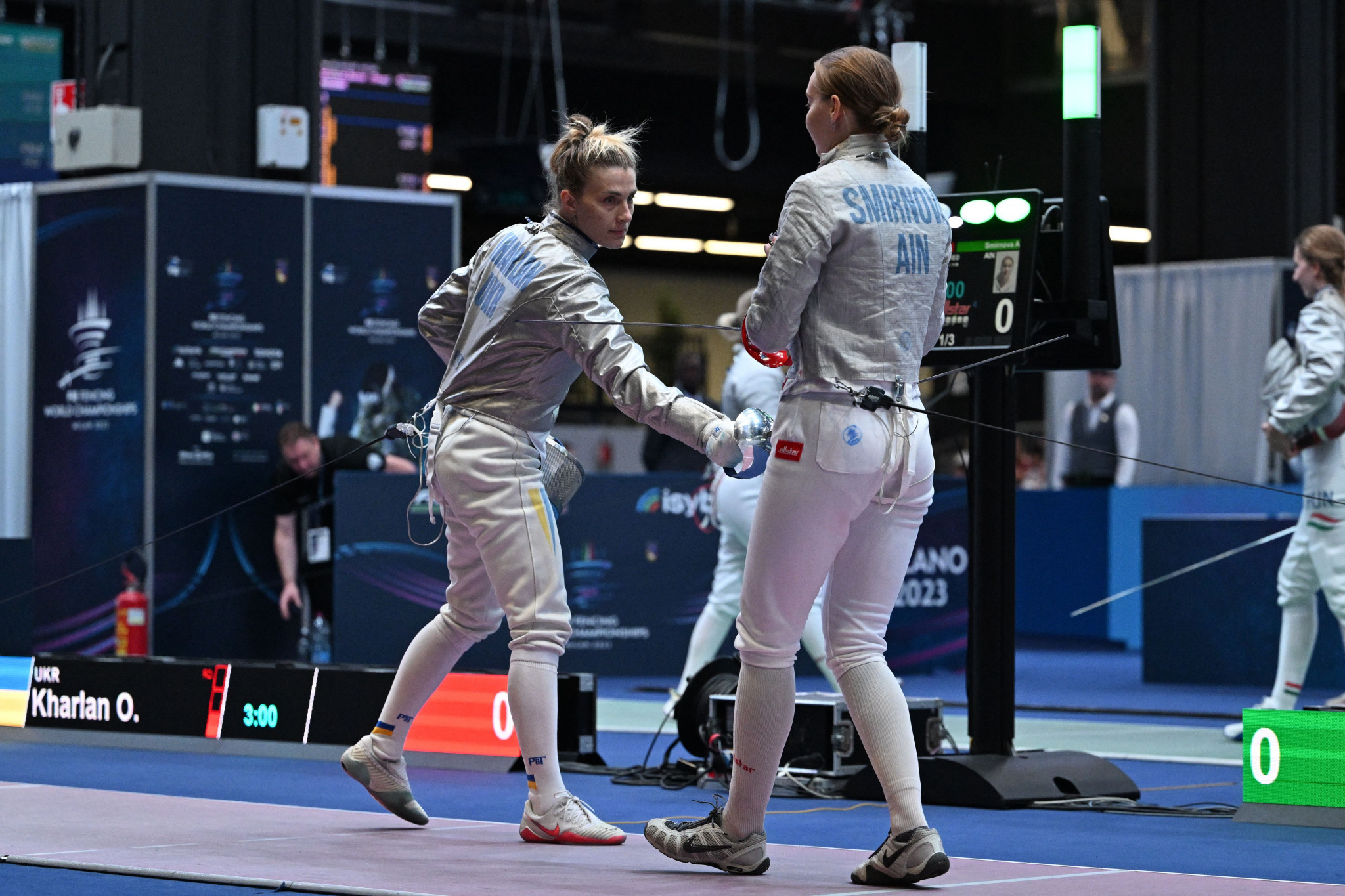 IOC President Thomas Bach promised Ukraine's Olha Kharlan, left, a place at Paris 2024 even if she did not qualify after she was disqualified at the Fencing World Championships in Milan when she refused to shake the hand of Anna Smirnova, right, her Russian opponent ©Getty Images