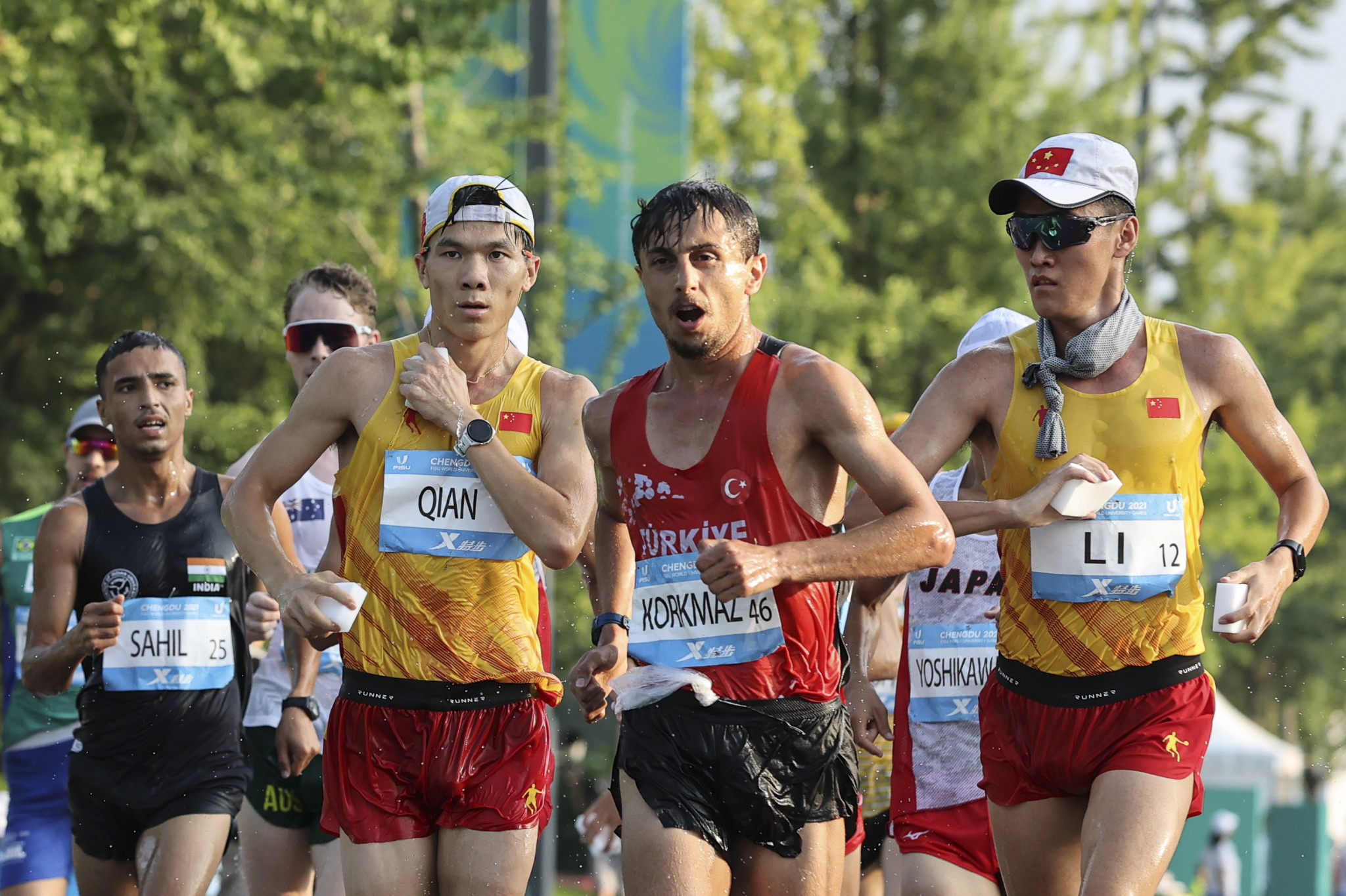 Salih Korkmaz of Turkey, centre, clocked 1:23:40 to win the 20km race walk final ©Chengdu 2021