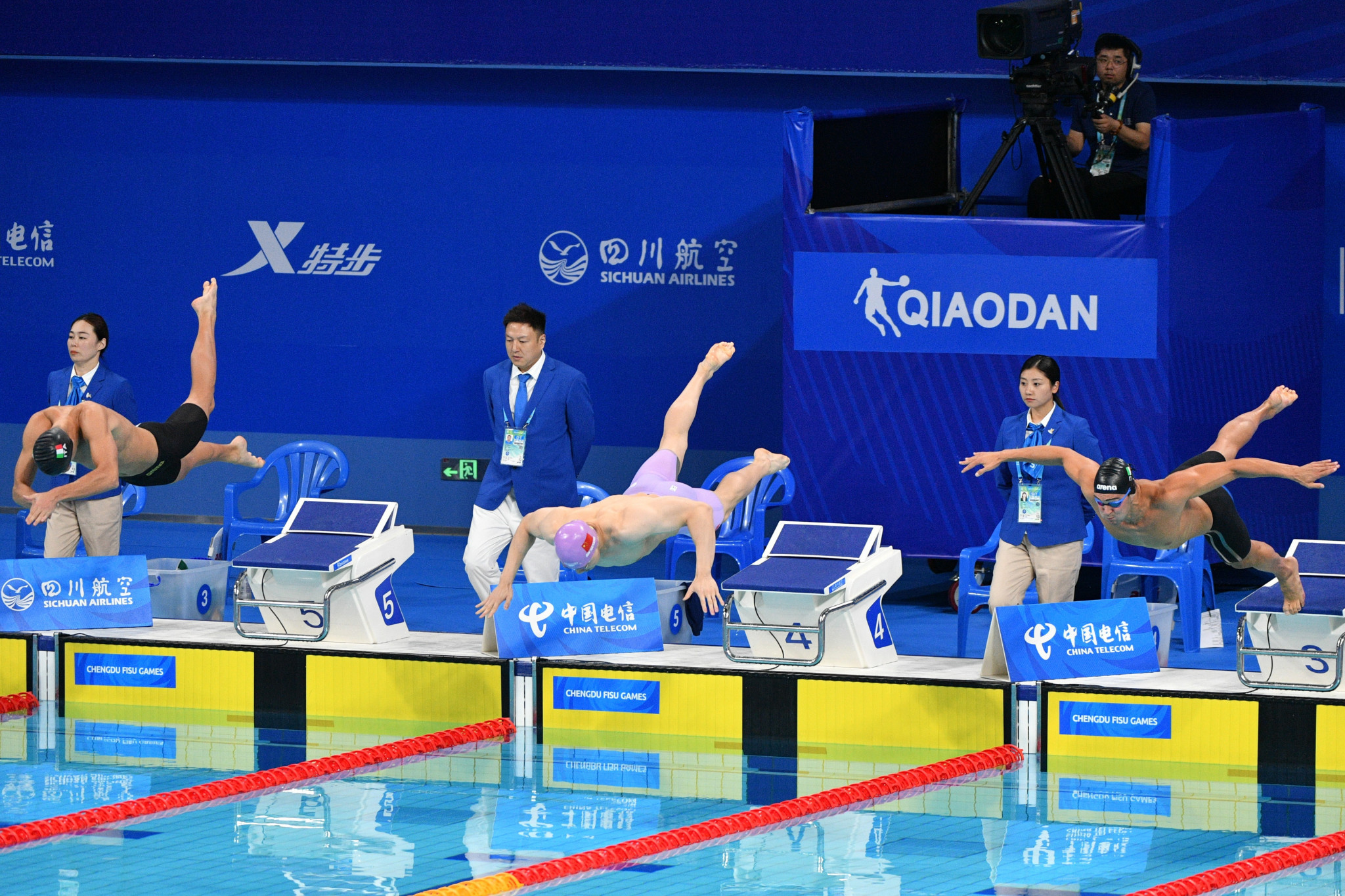 China's Qin Haiyang, centre, completed a clean sweep of breaststroke titles with success over 50m today ©Chengdu 2021