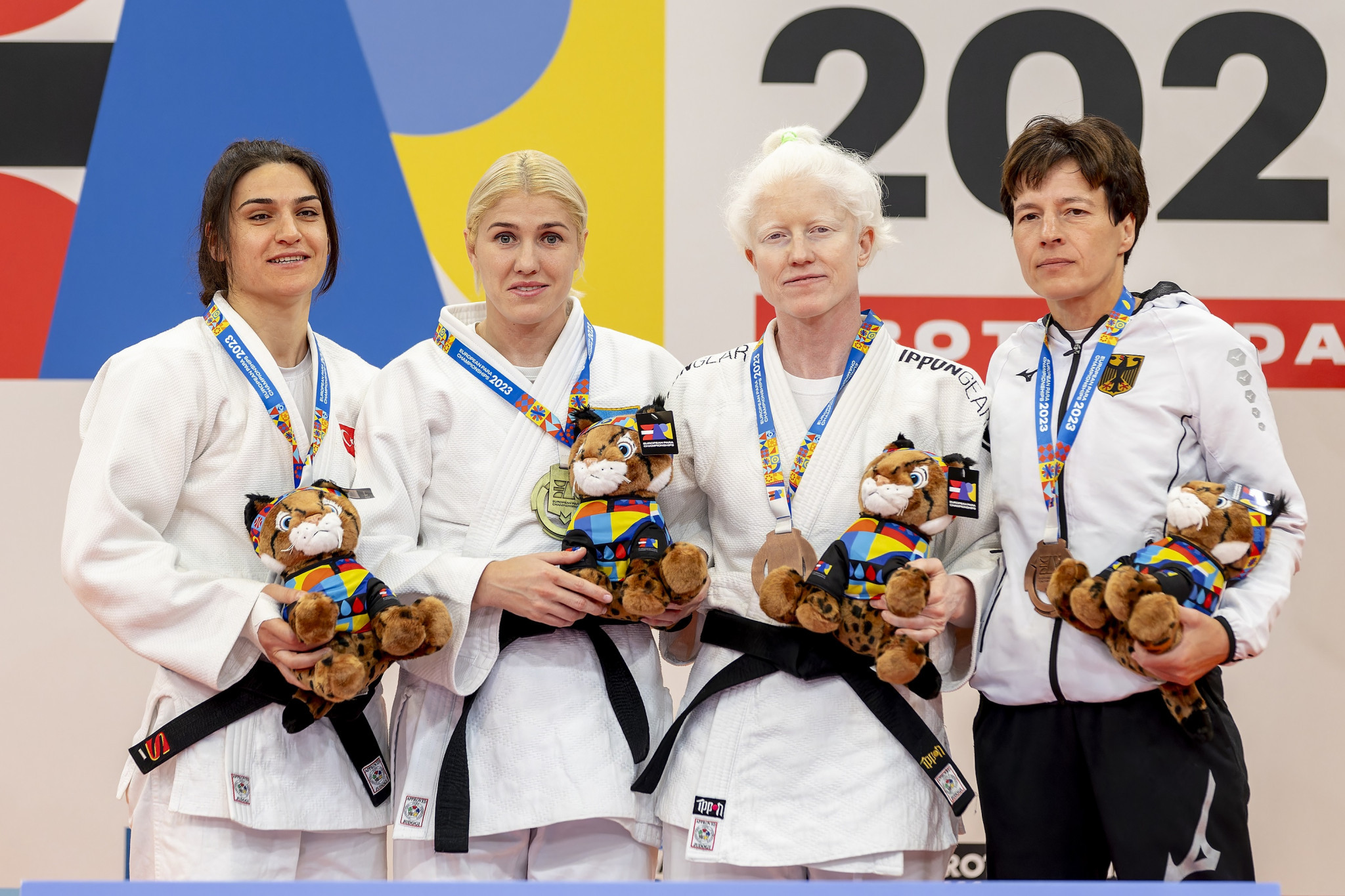 The J2 women’s under-57kg medallists receive their prizes at the medal ceremony ©EPC