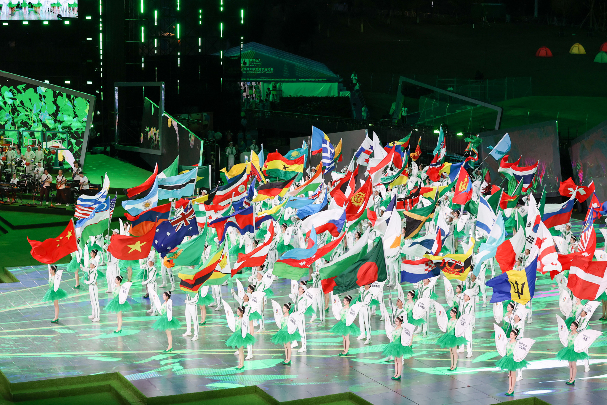 The flags of the participating nations arrive into the arena during the Closing Ceremony ©FISU