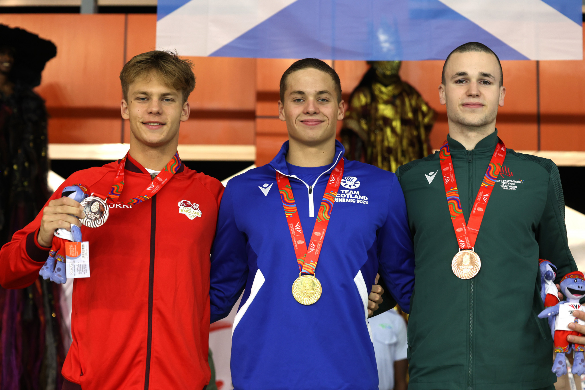 Scotland's Matthew Ward, centre, won his third swimming gold medal of Trinbago 2023 in the men's 200m backstroke ©Getty Images