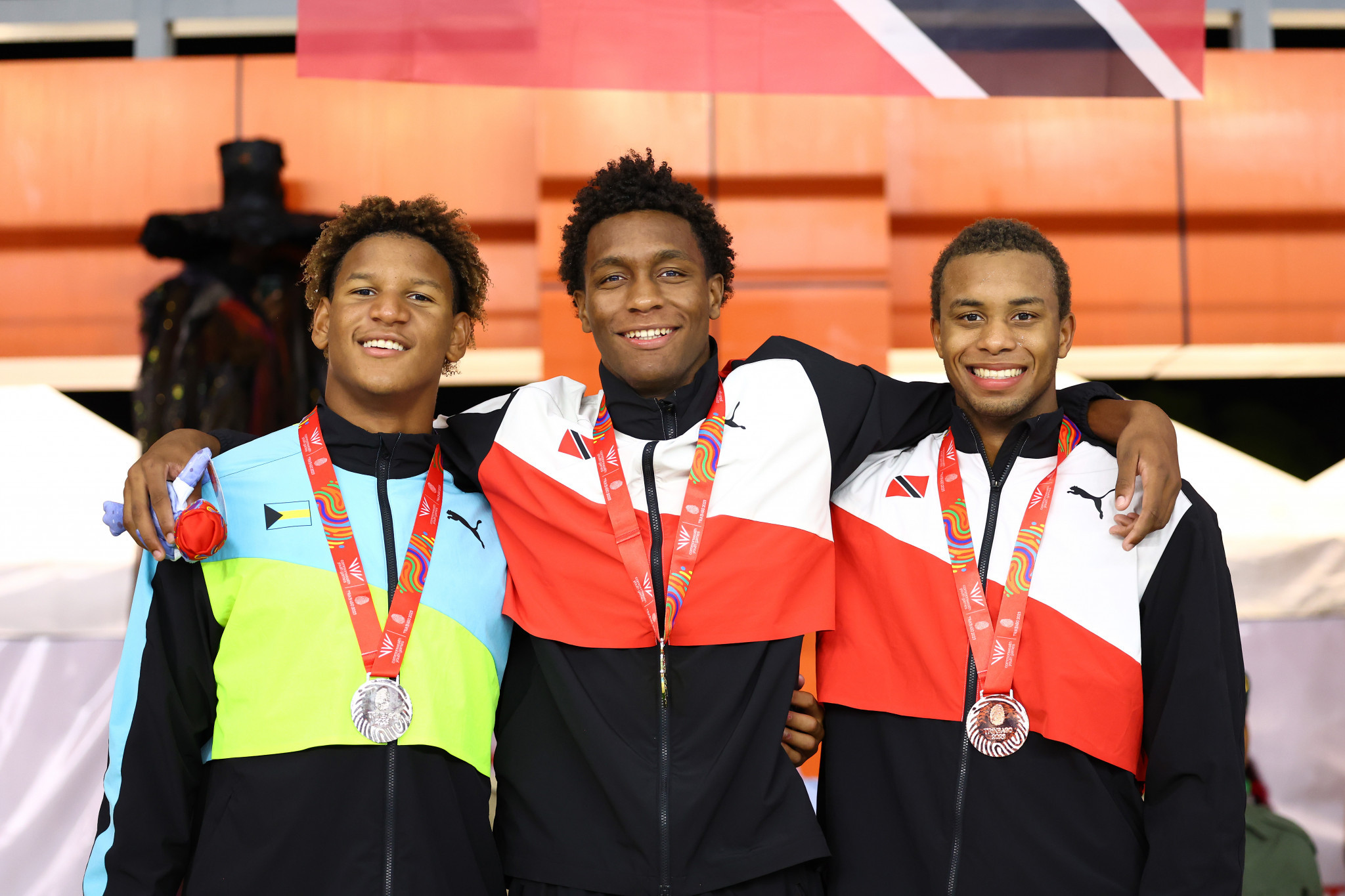 Trinidad and Tobago's Nikoli Blackman, centre, won his third gold medal at his home Commonwealth Youth Games in the men's freestyle races ©Getty Images
