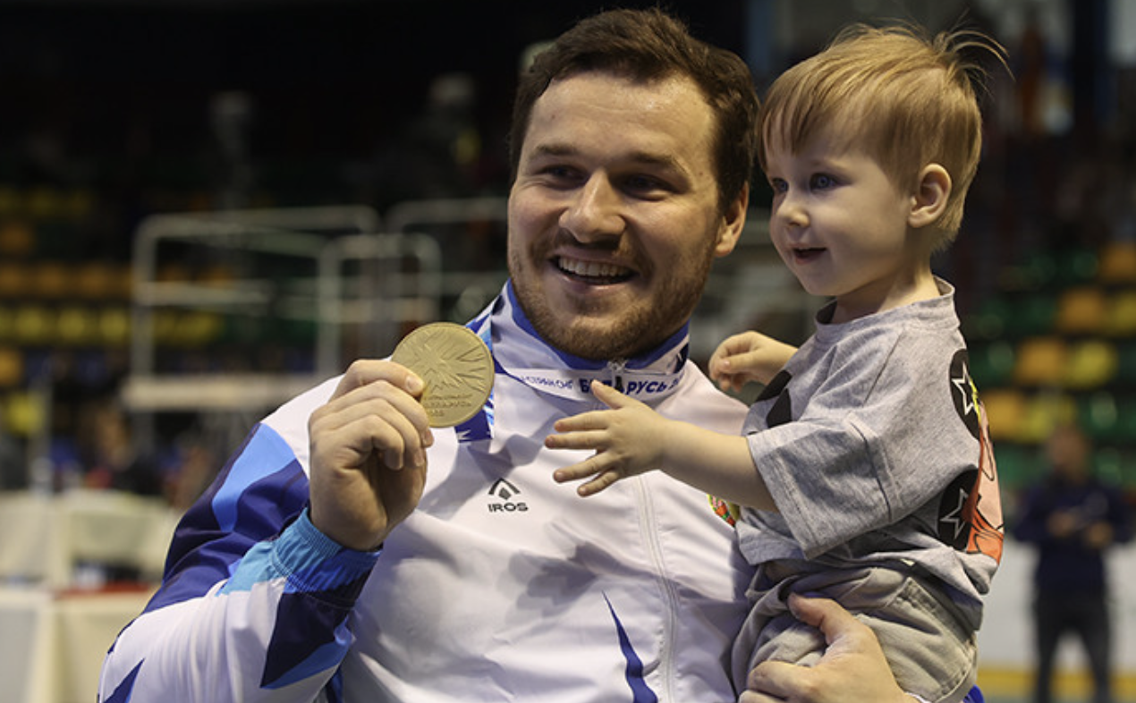 Petr Asayonak poses with his son after winning the 89kg gold ©BWF/Belta