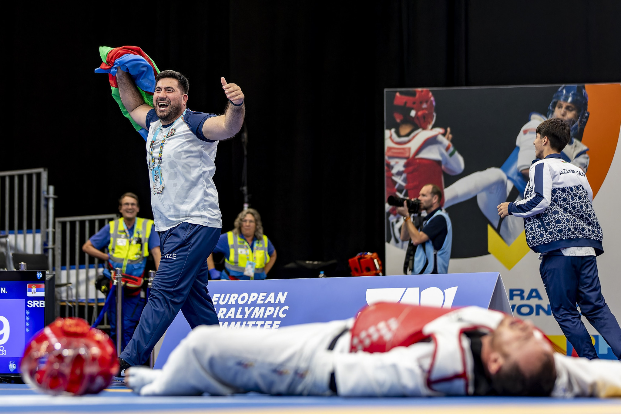 Azerbaijan's Abulfaz Abuzarli lies on the floor in disbelief after pulling off a remarkable victory as his coach celebrates wildly ©EPC