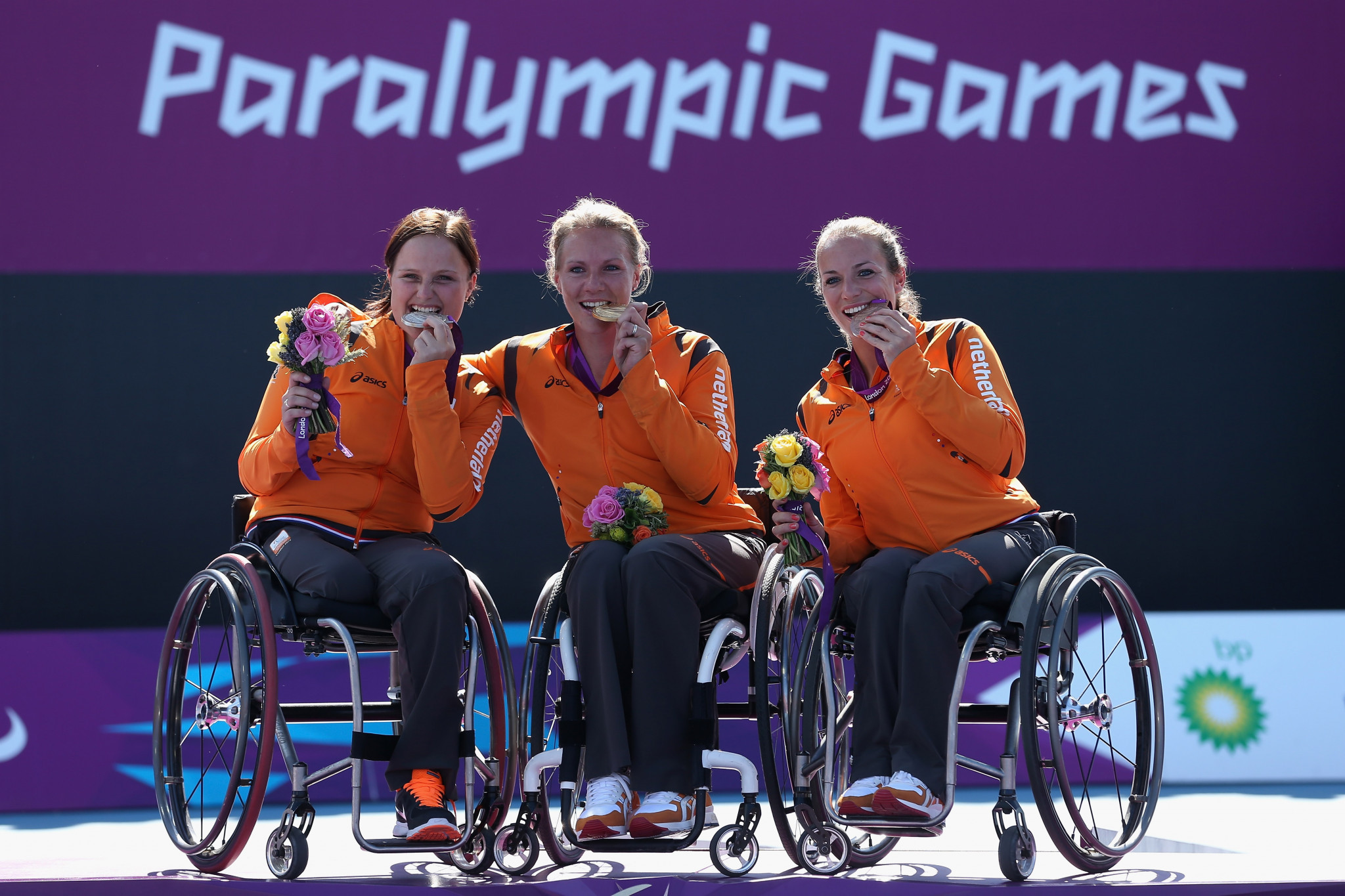Esther Vergeer, centre, is joined by Jiske Griffioen, right, and Aniek van Koot, left, when The Netherlands completed a clean sweep of women's singles medals at London 2012 ©Getty Images