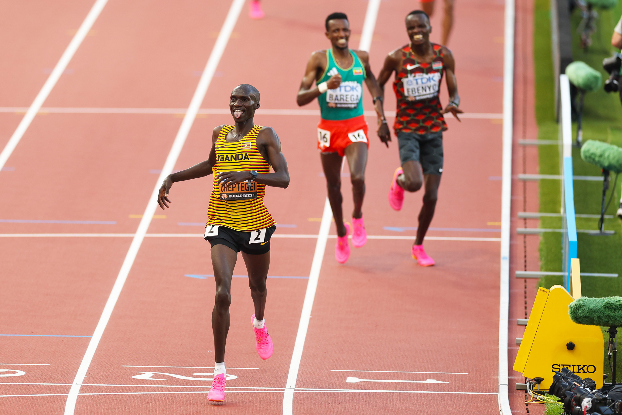 Uganda's Joshua Cheptegei, left, claimed his third consecutive men's 10,000m gold at the World Athletics Championships ©Getty Images