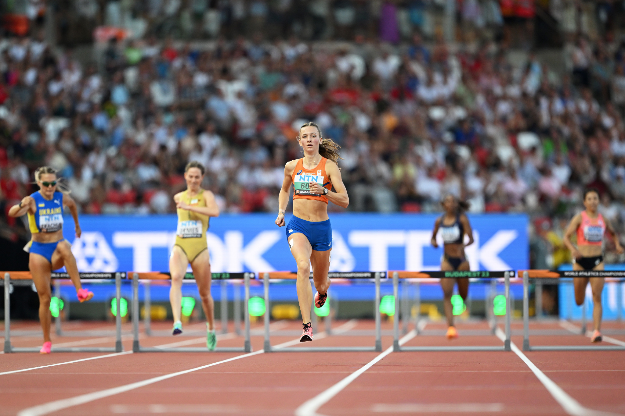 Femke Bol of The Netherlands, centre, overcame the disappointment of stumbling in the closing stages of the mixed 4x400m relay final by comfortably winning her women's 400m hurdles heat ©Getty Images