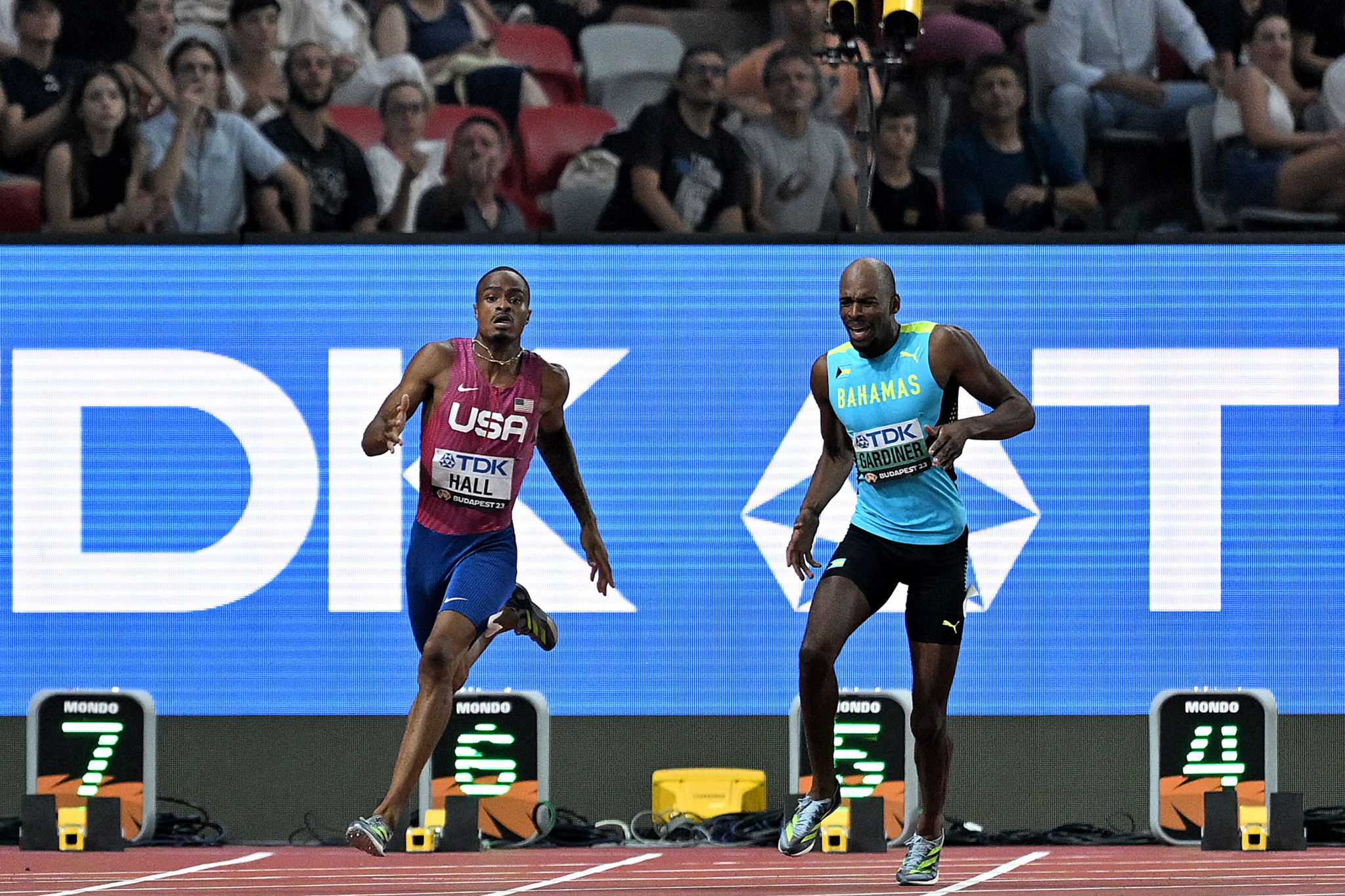 Olympic champion and men's 400m favourite Steven Gardiner of the Bahamas, right, suffered a hamstring injury during his semi-final ©Getty Images
