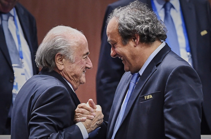 Sepp Blatter is congratulated by UEFA head Michel Platini following his election victory ©AFP/Getty Images