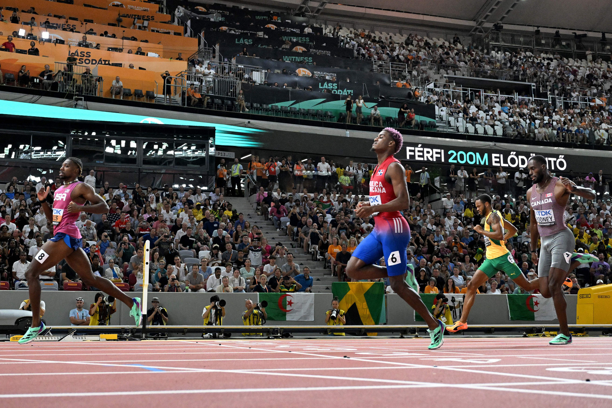 American back-to-back 200m world champion Noah Lyles, left, was involved in the crash but clocked the quickest time in the semi-finals at 19.76 ©Getty Images