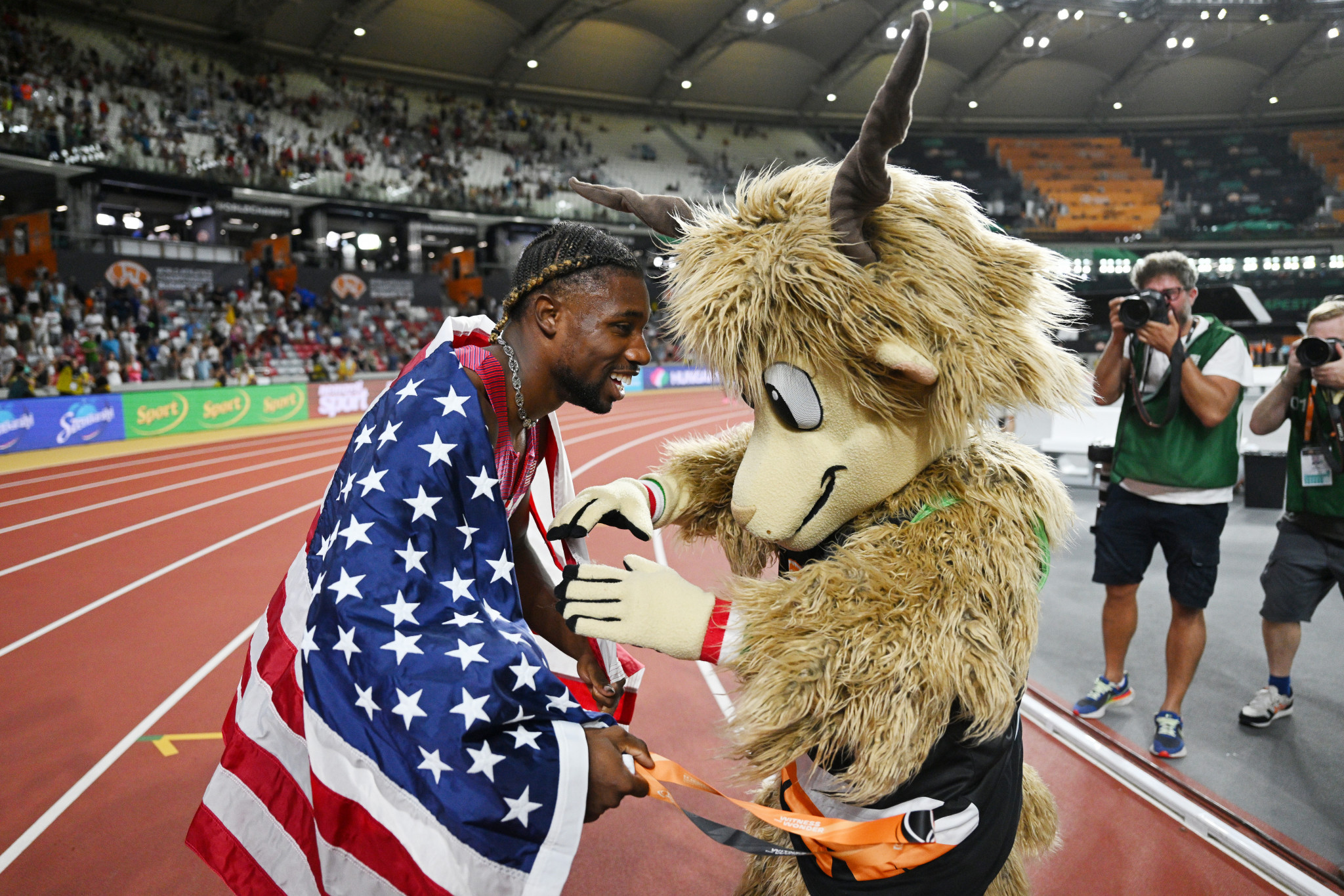 Noah Lyles of the US celebrated a World Championships 100m and 200m double with mascot Youhuu ©Getty Images