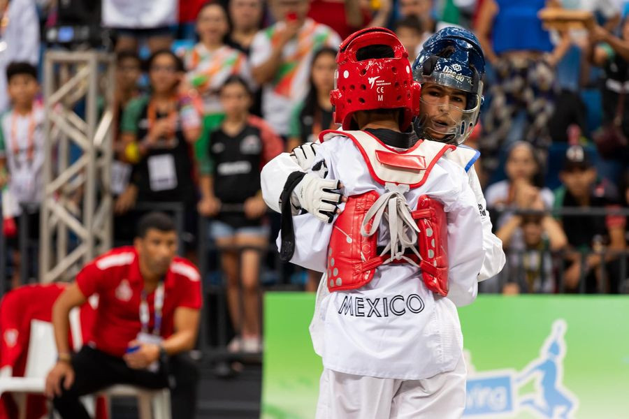 Taekwondo athletes embrace each other after contest ©ISF