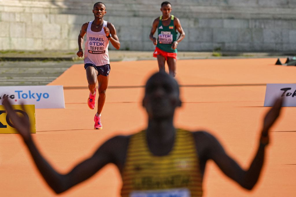 Israel's Maru Teferi, despite a heavy fall with around 10km to go in the men's marathon, moved up to win silver on the final run-in as he passed Ethiopia's Leul Gebresilase ©Getty Images