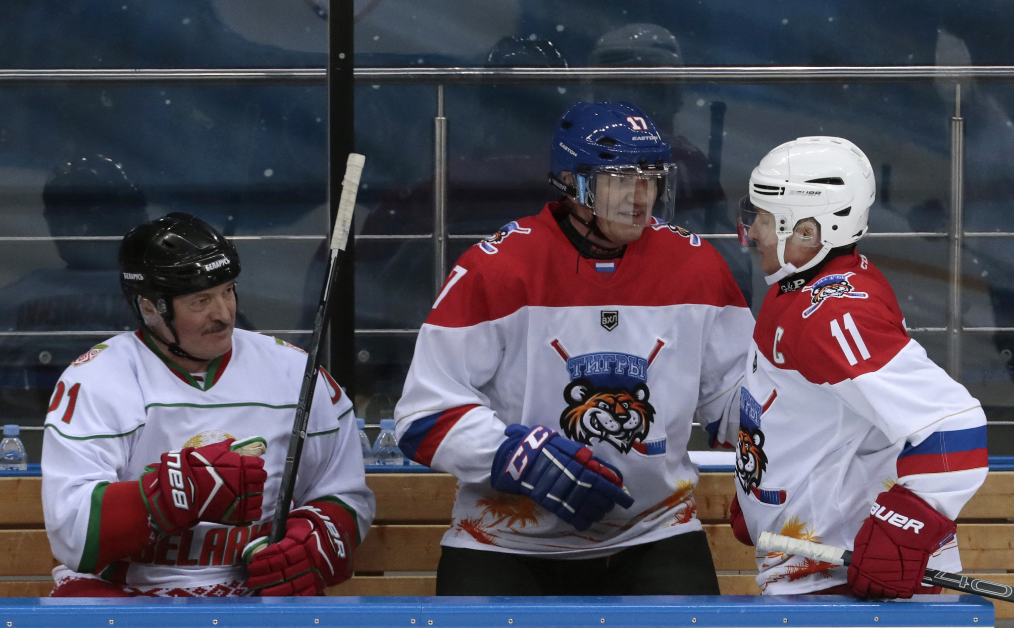 Gennady Timchenko, centre, is also Kontinental Hockey League President and reportedly an ally of Russian President Vladimir Putin, right ©Getty Images