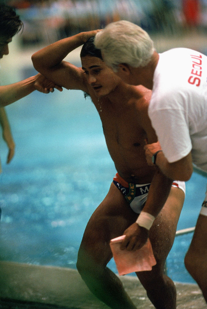 United States diver Greg Louganis is helped from the pool after hitting his head on the 3m springboard in the preliminary competition - he returned to qualify and retained his title the following day ©Getty Images 
