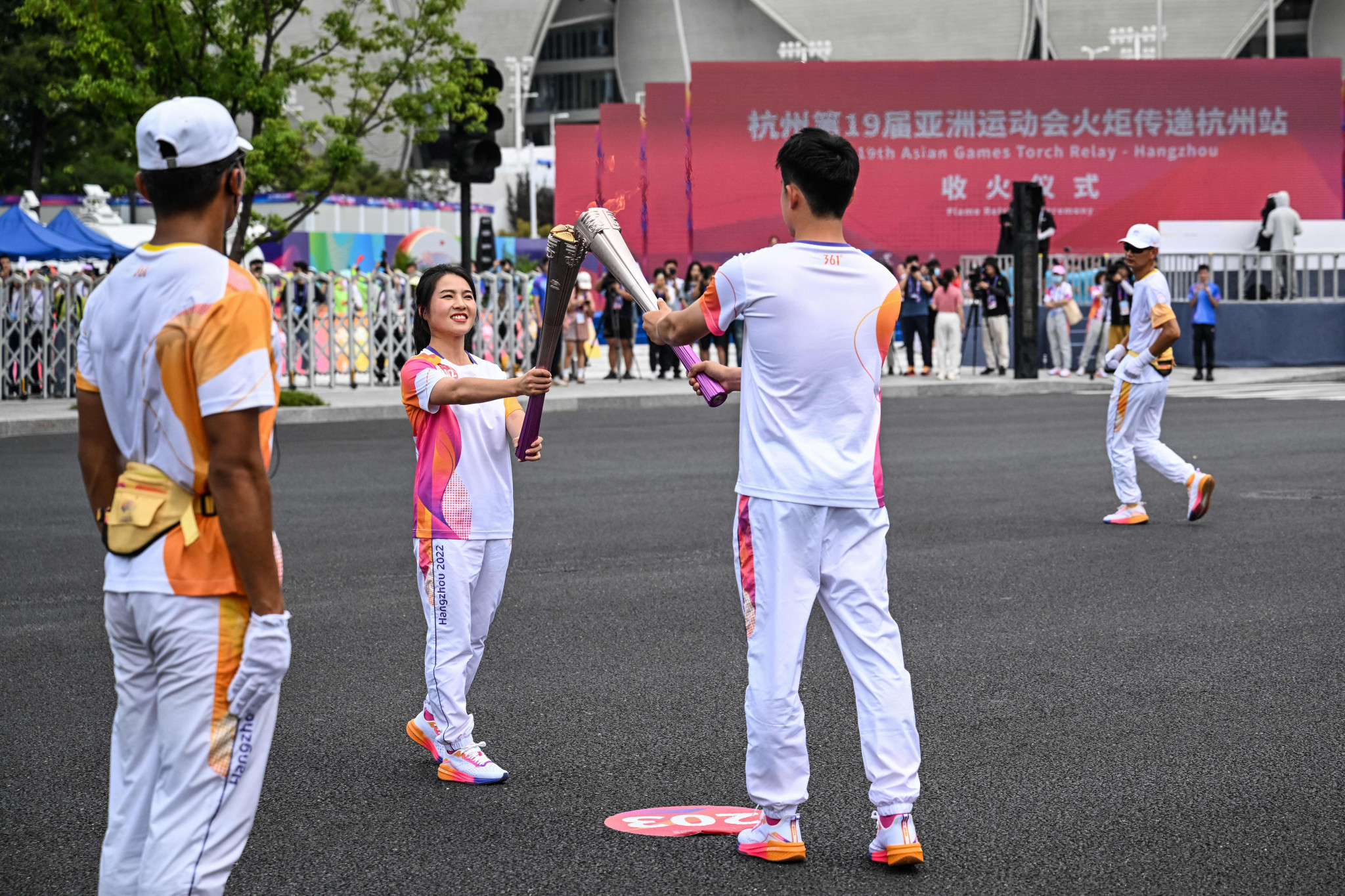 Wu Yibing, right, completed the last leg of the Hangzhou 2022 Torch Relay ©Getty Images