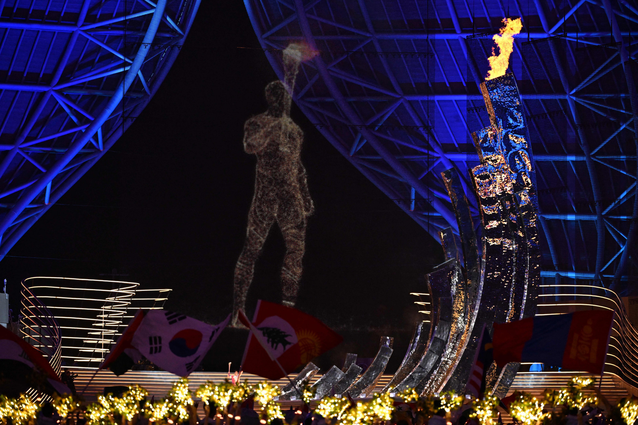 A giant digital Torchbearer joined China's Olympic swimming champion Wang Shun to light the Cauldron ©Getty Images