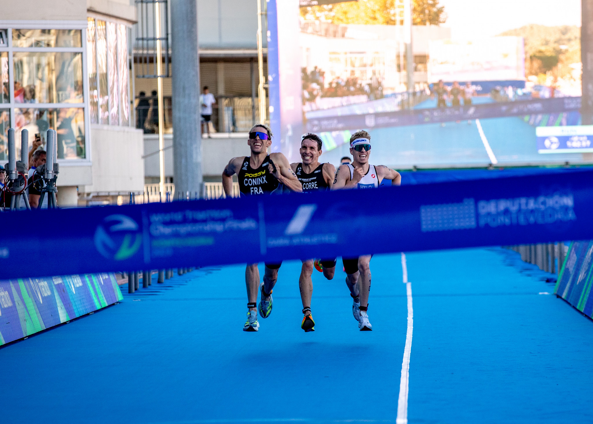 France's Dorian Coninx, left, held off Germany's Tim Hellwig, right, and Pierre Le Corre of France, centre, in a finishing sprint to win the race and claim the world title ©World Triathlon