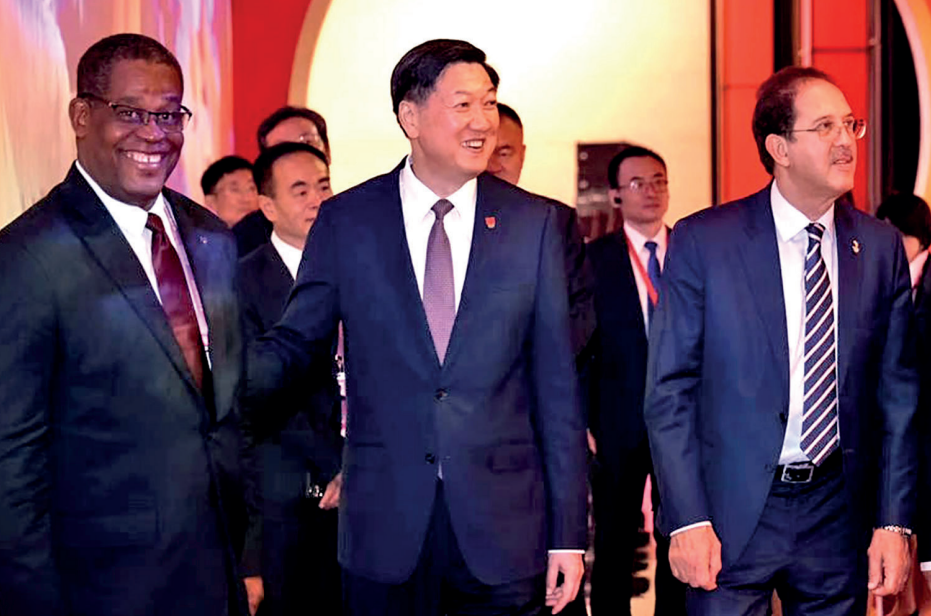 ANOCA President Mustapha Berraf, right, asked Gao Zhidan, centre, to relay 