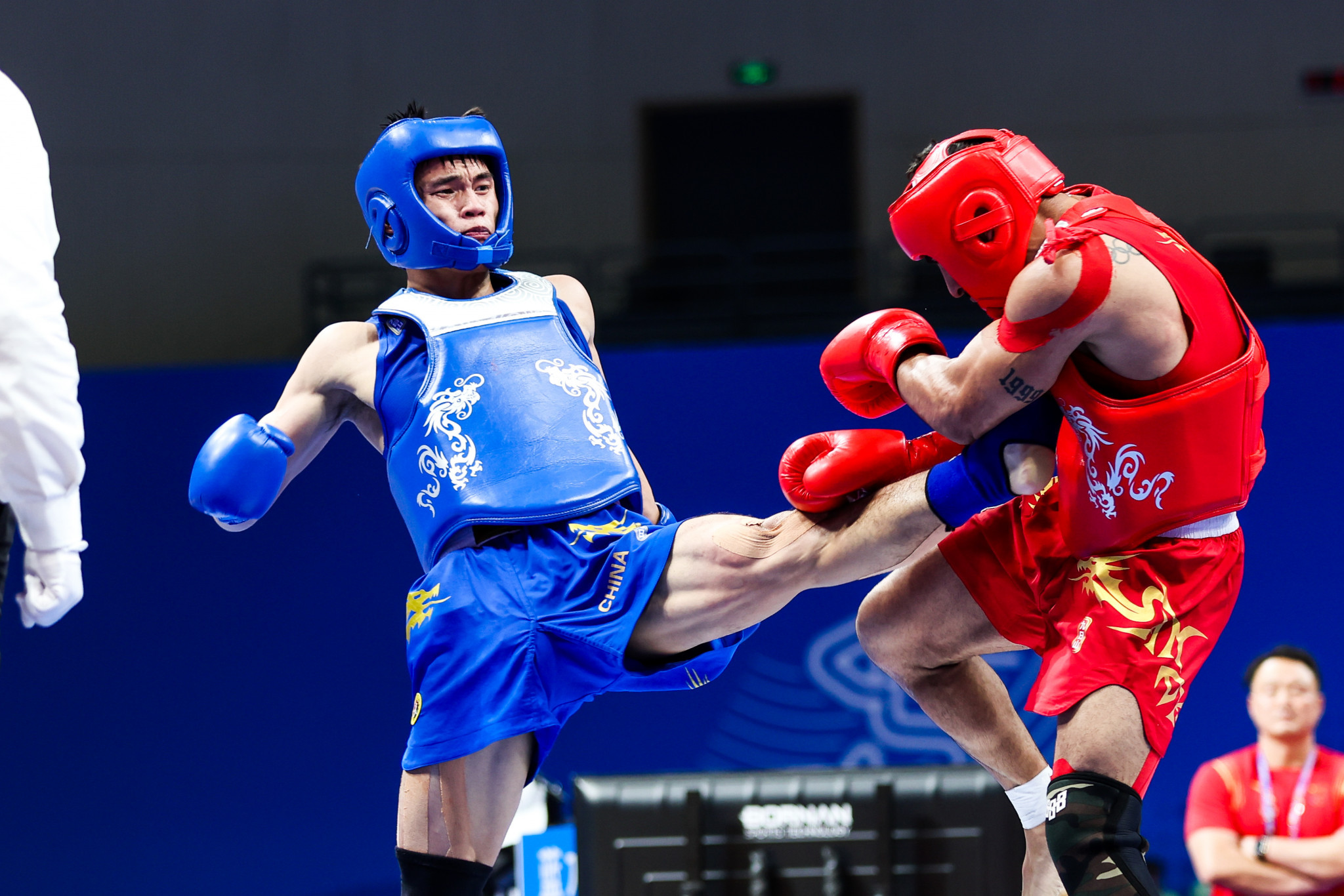 He Feng, left, secured a fifth wushu gold medal for China after coming from behind to defeat Iran's Mohsen Mohammadseifi ©Hangzhou 2022