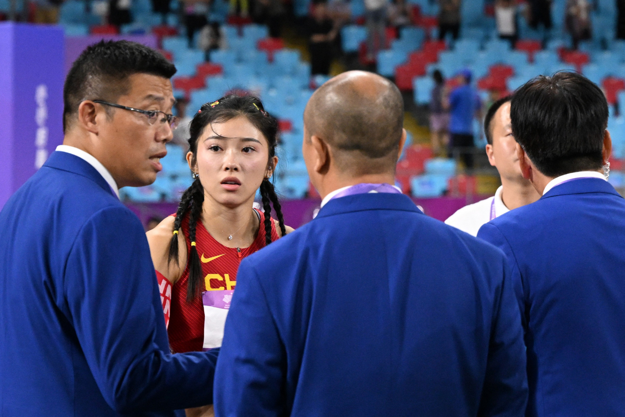 Wu Yanni looks stunned after being told that she had been disqualified for a false start despite being allowed to race the women's 100 metres hurdles final ©Getty Images