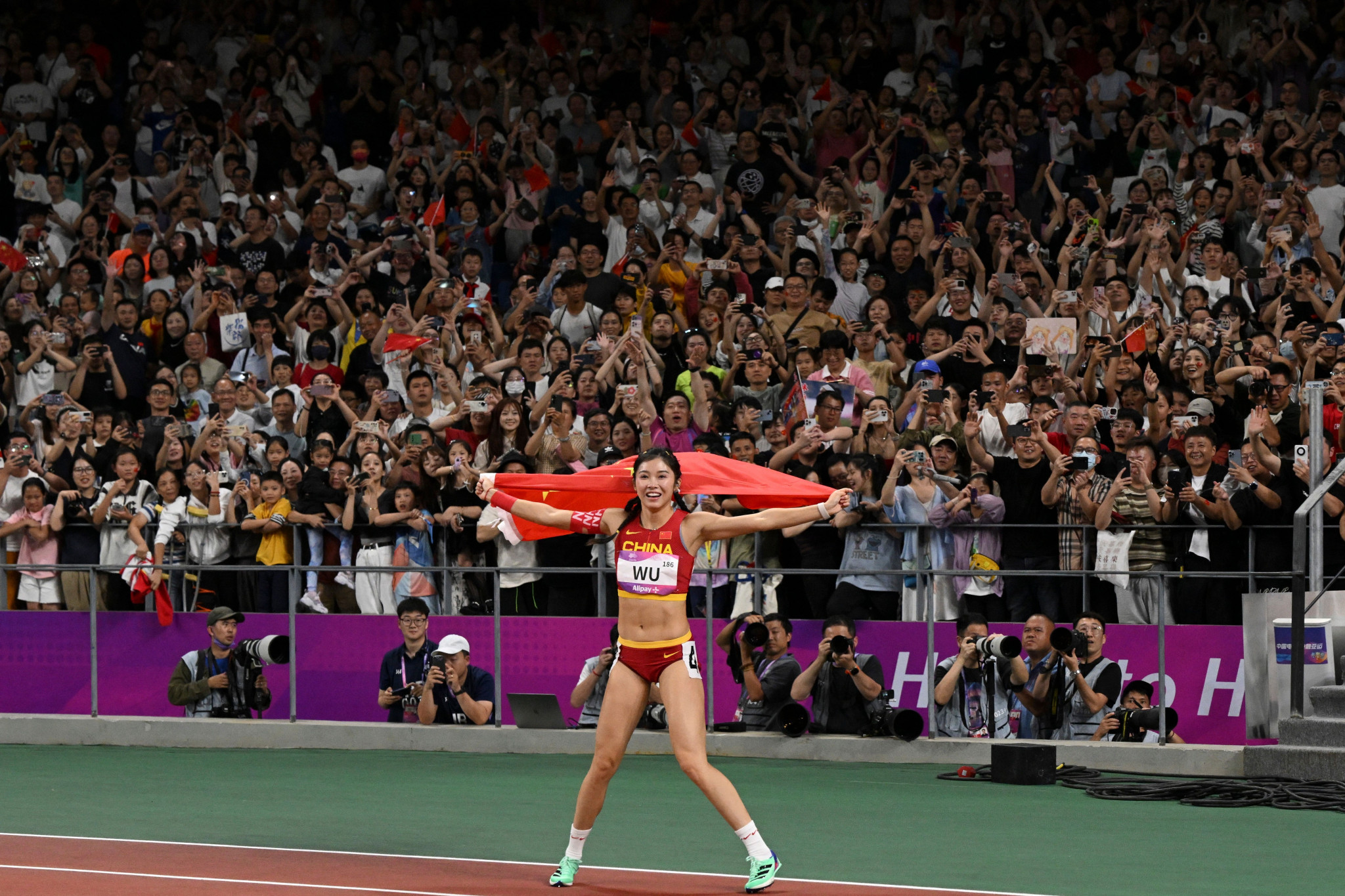Wu Yanni of China celebrates winning silver only to be disqualified moments later on a night of athletics drama ©Getty Images
