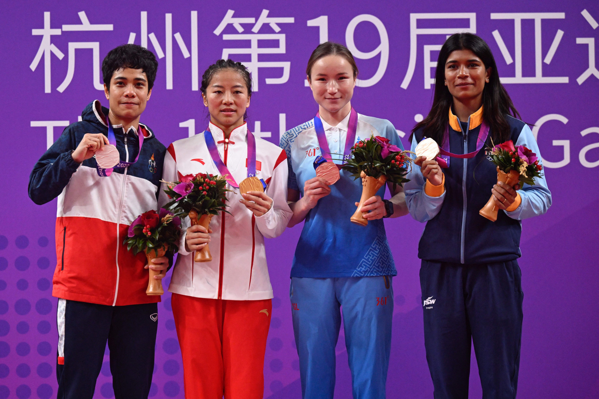Wu Yu, second from left, claimed top spot as all four medallists in the women’s 50kg division secured quota spots for Paris 2024 ©Getty Images