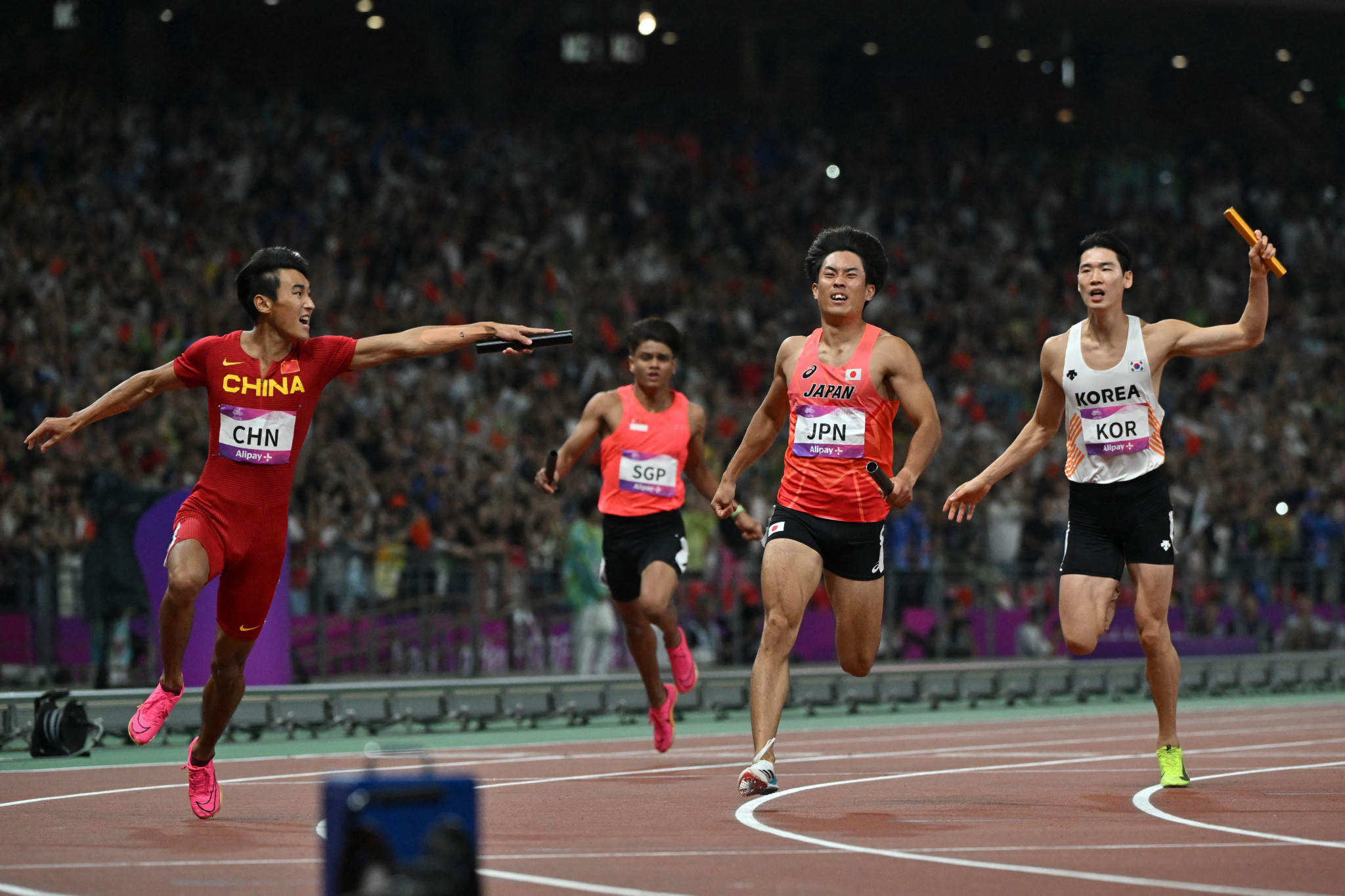 Chen Jiapeng, left, celebrates after helping China win the men's 4x100m relay title ©Getty Images