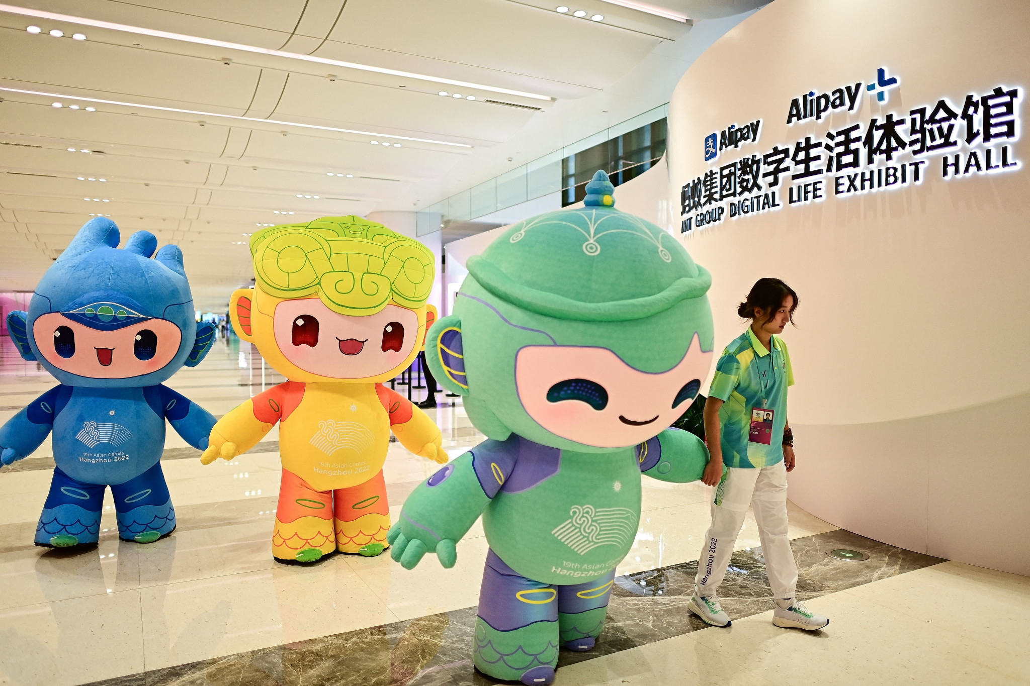 Chenchen, left, is one of Hangzhou 2022's mascots that will exchange gifts for compliments ©Getty Images