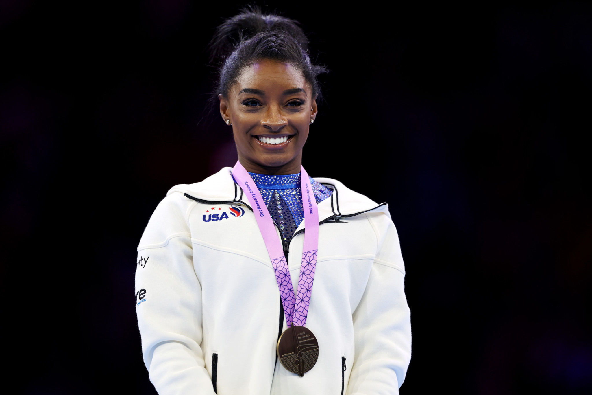 Simone Biles is all smiles after winning a record 21st gold medal at the World Artistic Gymnastics Championships ©Getty Images  