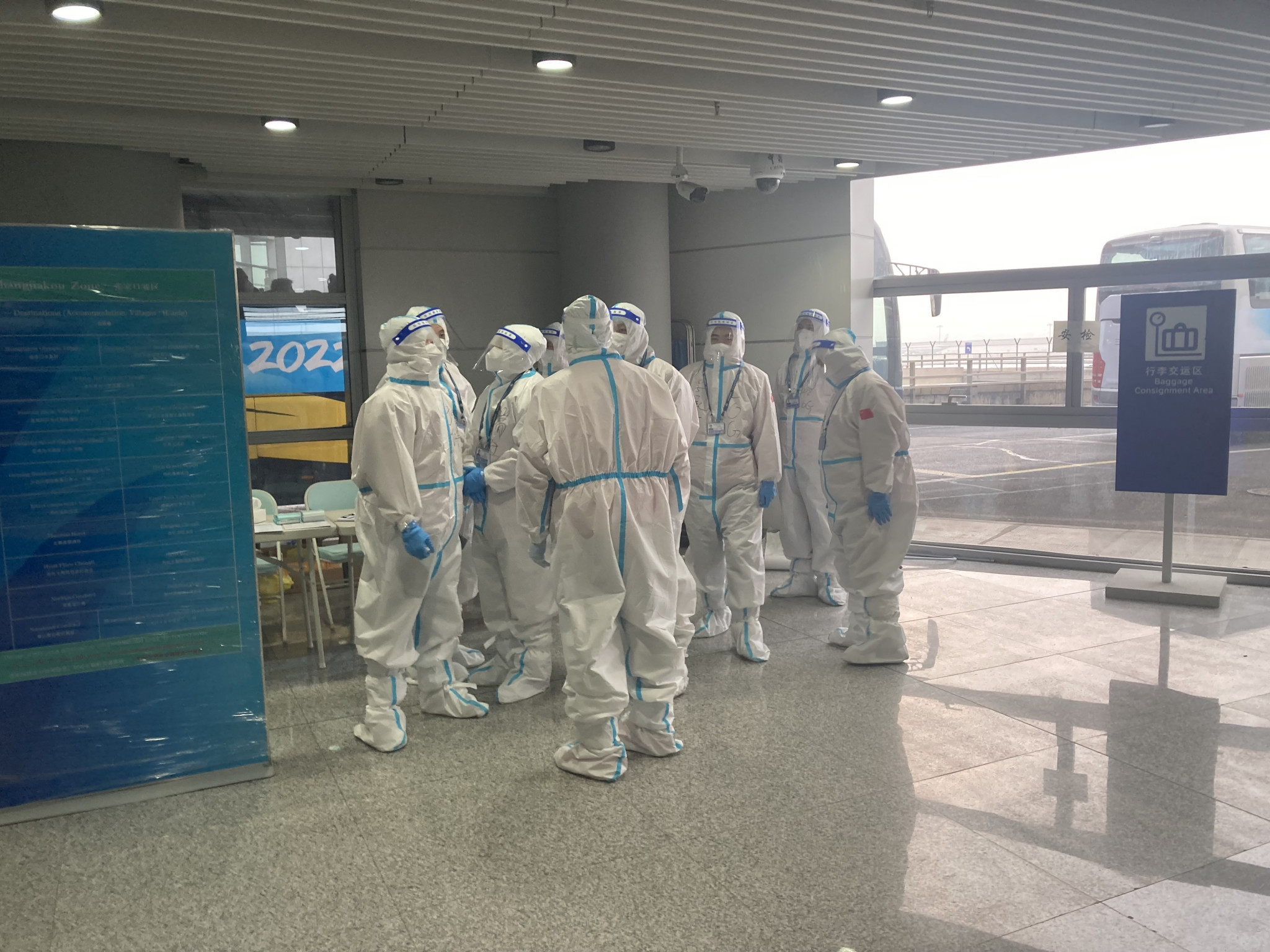 Airport workers dressed in hazmat suits greeted foreign visitors following their arrival in Beijing prior to the 2022 Winter Olympics ©ITG