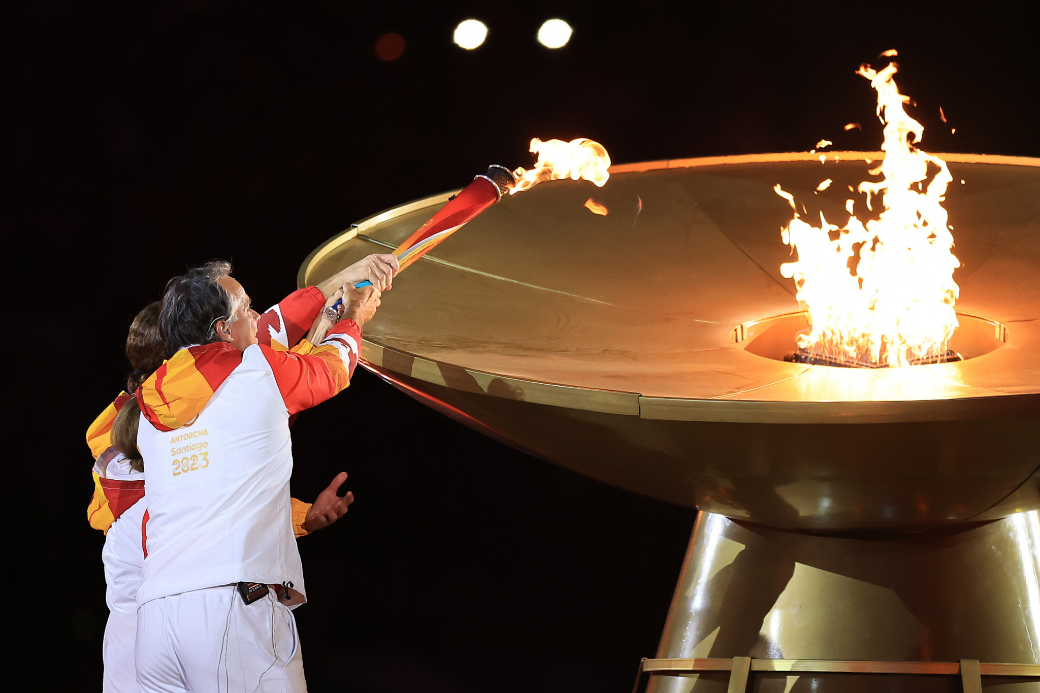 Chile's first Olympic gold medallists Nicolas Massu and Fernando Gonzalez joined 93-year-old Luvy Lopez to light the Cauldron for the Opening Ceremony at Santiago 2023 ©Getty Images